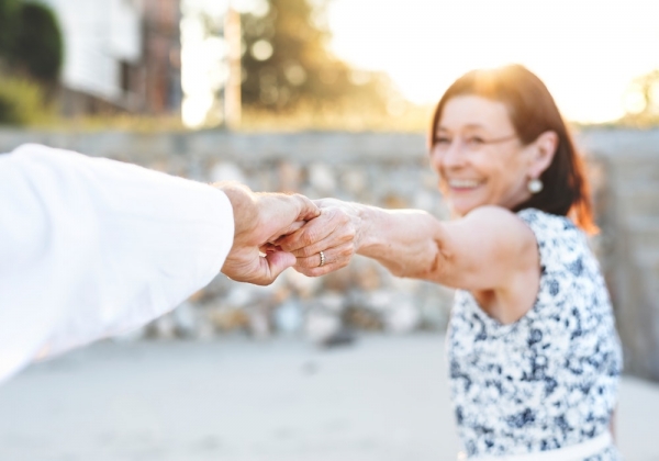 smiling woman while holding hands during daytime