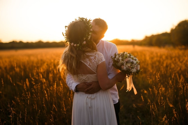 男人和女人站在互相親吻的棕色草地前